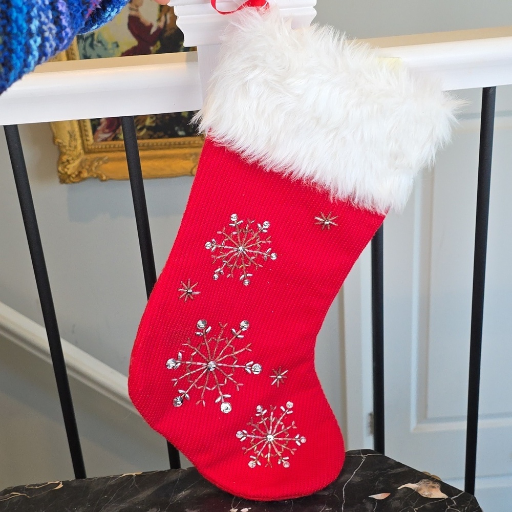 Knit red holiday stocking with snowflake beaded embroidery